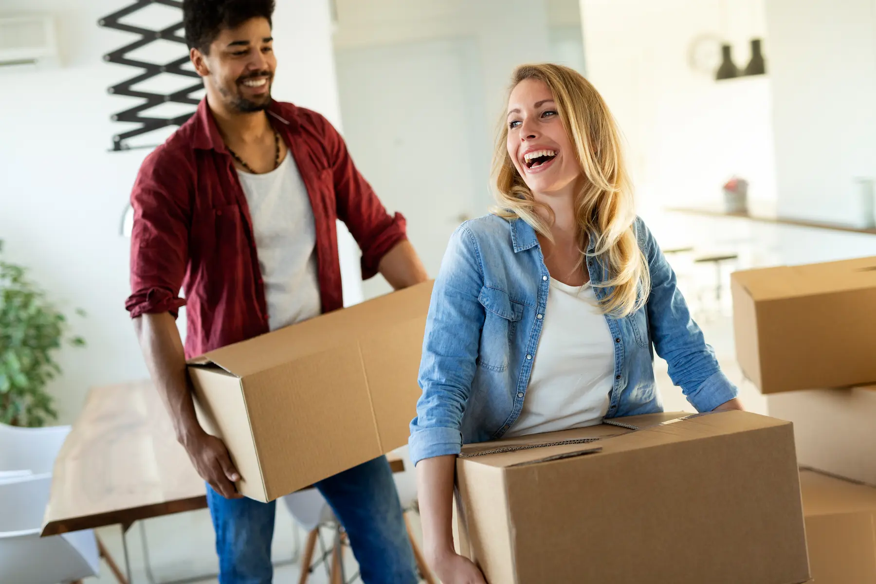 happy couple having fun while moving in san diego